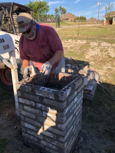 Brian with Dusty Acres Skid Steer building a brick mailbox